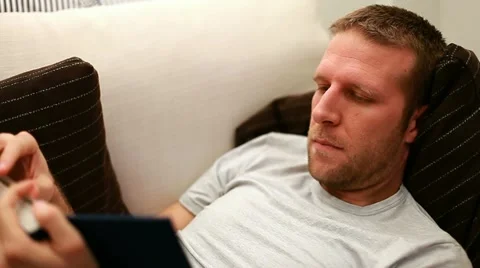 Man reading on sofa Video stock 11374501