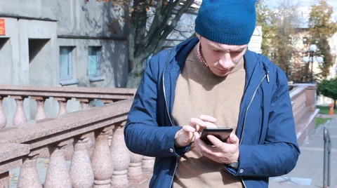 Man reading on the street sitting of Notebook Stock Footage 55440025