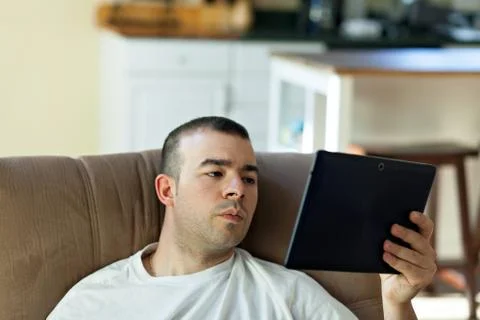 Man Reading a Tablet Computer Stock Photos