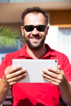 Man reading tablet. Focus on tablet. Stock Photos