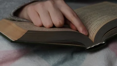 A man reads a book lying in bed. Time for yourself, rest and hobbies. Stock Footage 223371958