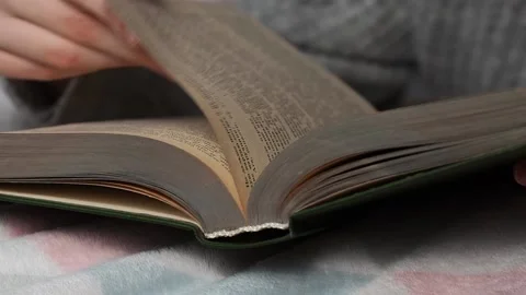 A man reads a book lying in bed. Time for yourself, rest and hobbies. Stock Footage 223371964