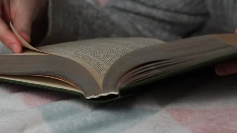 A man reads a book lying in bed. Time for yourself, rest and hobbies. Stock Footage 223371966