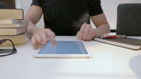 A man reads an ebook on a tablet Stock Footage 82178199