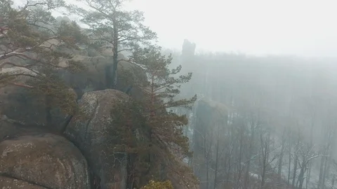 Man reads a map sitting on the top of the mountain covered with fog Stock Footage 87116765