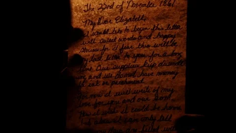 Man reads old letters by a fire Stock Footage 101120265