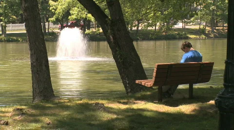 Man reads in the park (2 of 3) Stock Footage 840503