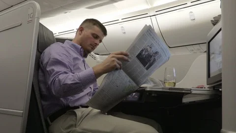 Man Reads on Plane Wide 4K Stock Footage 89292017