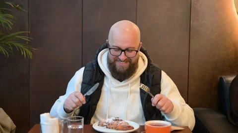 Man ready to enjoy delicious dessert in cozy cafe with warm atmosphere and Stock Footage 346726153
