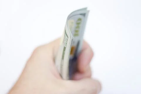Man ready to exchange pack of Paper Dollars Usa On The White Background Stock Photos
