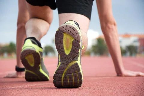 Man ready to run on the track Stock Photos