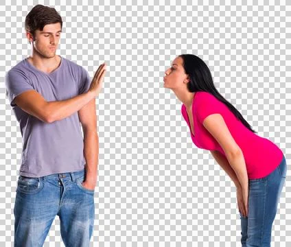 Man rebuffing the kiss of his girlfriend Stock Photos