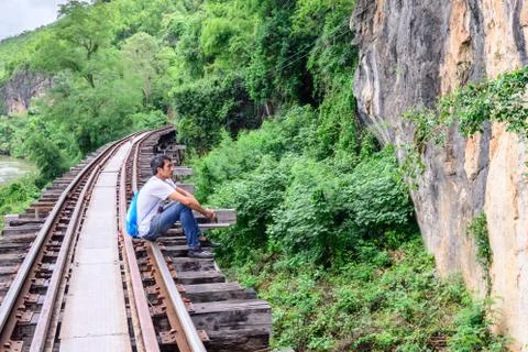 Man recapturing about the World War II at Death Railway, Kanchanaburi Thailan Stock Photos