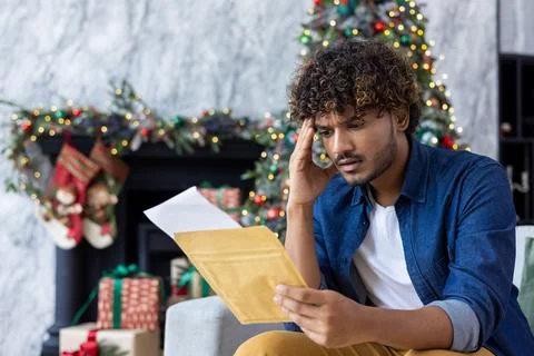 Man received postal envelope letter with bad news, upset disappointed hispanic Stock Photos