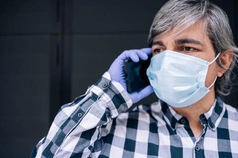 Man receives call asking for help to make purchase of person in need Stock Photos