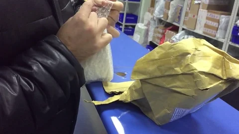 The man receives indoor the parcel at the post office. Mail international Stock Footage 83056655