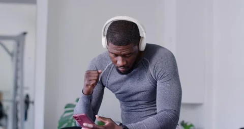 Man receiving message on pink phone scrolling and pumping fist psyching up on Stock Footage 340654637