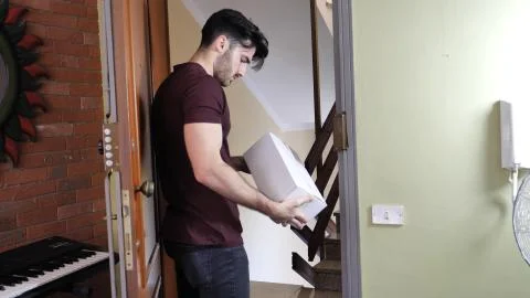 Man receiving package at home Stock Photos