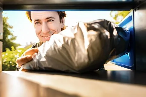 Man is receiving a package from a parcel locker. This pickup delivery servi.. Stock Photos