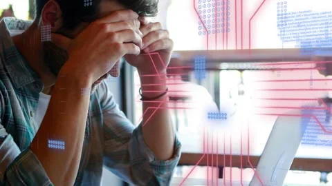 Man receiving phone ping, debugging code on laptop while digital overlays Stock Footage 333720371