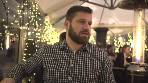 Man receiving placed order in cafe, evening, portrait, Christmas time, steadycam 動画素材 72782574