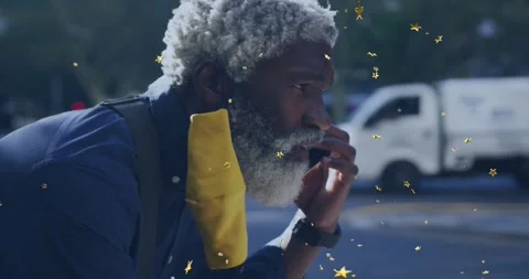 Man receiving tech call on street, holding phone, focusing, golden stars Stock Footage 332296434