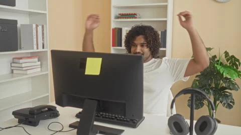 Man reclining at computer with hands behind head at office desk in building.. Stock Footage 337395693