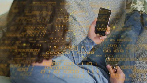 Man reclining on sofa rotating smartphone and activating code overlay tracking Stock Footage 333999037
