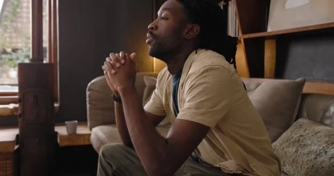 Man reclining on sofa shifting to sitting upright, rubbing hands and covering Stock Footage 339321488