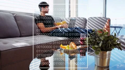 Man reclining sofa typing, starting white frame with binary overlay over laptop Stock Footage 333510078