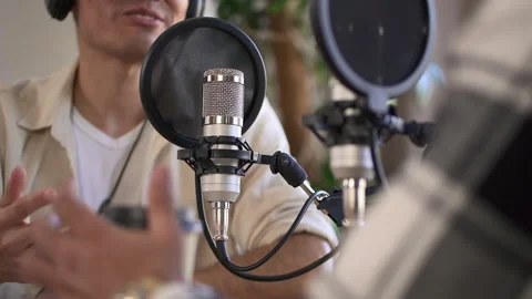 Man record audio mic content or conduct a radio program with coworker in Stock Footage 170254297