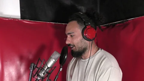 Man in recording booth on microphone. Video stock 114010107