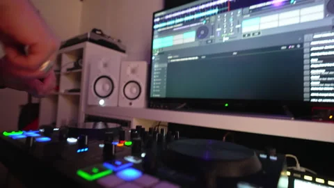 A man recording music using mixing console and computer at home studio setup Stock Footage 232660969