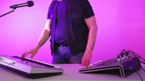 A man in a recording studio singing plays a synthesizer Stock Footage 132825200