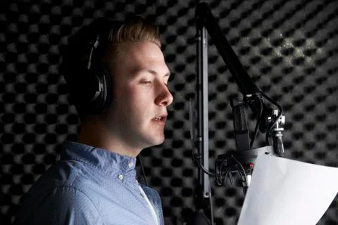 Man In Recording Studio Talking Into Microphone Stock Photos