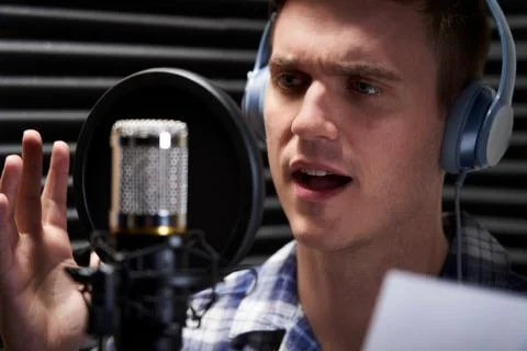 Man In Recording Studio Talking Into Microphone Stock Photos