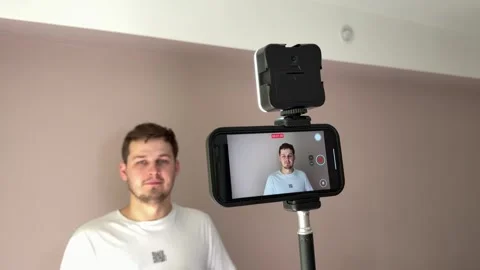 Man Recording Talking Video with Tripod and Light Stock Footage 312557793