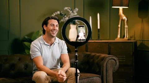 Man recording video using smartphone and ring light Stock Photos