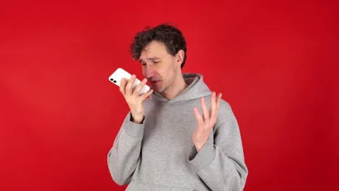 Man recording voice message on smartphone, talking speakerphone. Stock Footage 304749779