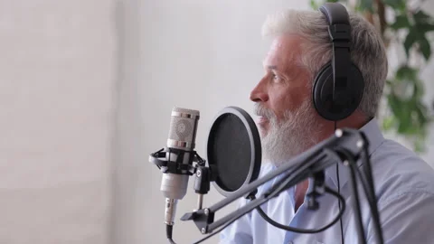 Man records a podcast or interview with a microphone in a recording studio Stock Footage 171543017