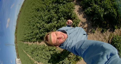 Man records selfie video using wide-angle lens for social media content creation Stock Footage 276240200