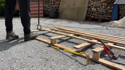 Man recycles wood from a pallet using a lifting and demolition fork Stock Footage 311092361