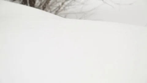 Man in red boots and blue jeans sneaking through the snow, leaving  footprints. Stock Footage 70344698
