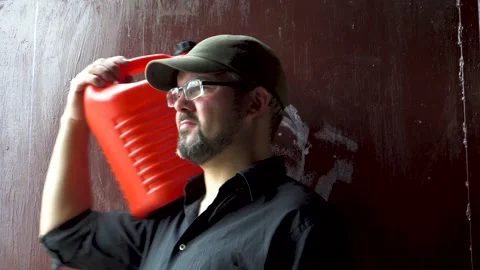 Man with red canister 4K Video stock 196727482