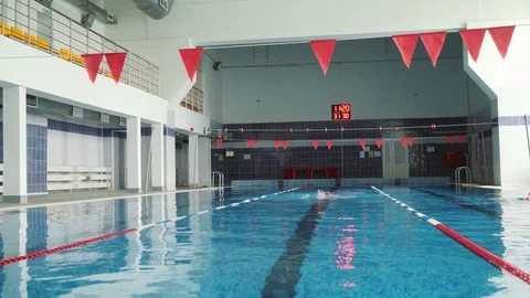 The man in the red cap swims in the pool. 4k Stock Footage 98122530