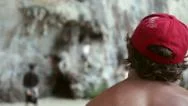 Man With A Red Cap Is Watching On Climbers On The Rock Wall. Thailand Stock Footage