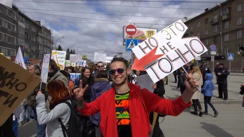 A man in red clothes with dreadlocks smiles into the camera. Stock Footage 75289147