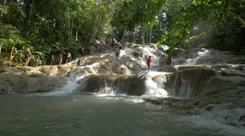 Man in red clothes at Dunn's River Falls in Jamaica Stock Footage 50689528