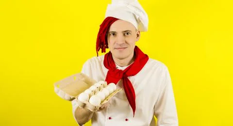 Man with red dreadlocks holds it in his hand chicken eggs. Confident young co Stock Photos