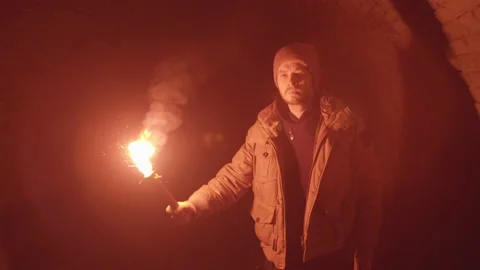 Man with Red Flare Torch walking through Medieval Dungeon Tunnel Stock Footage 170726484